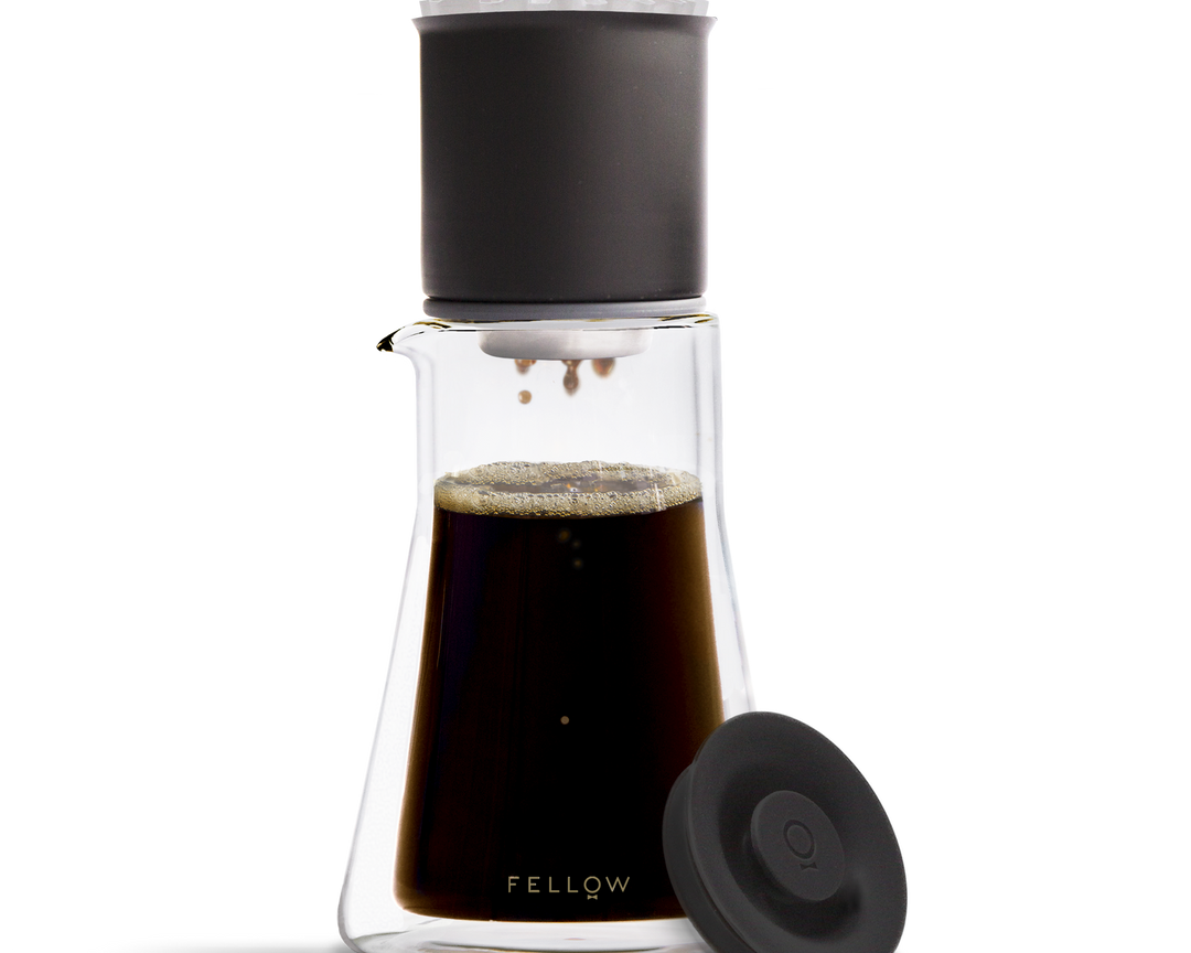 Coffee maker with black lid and clear body on a white background